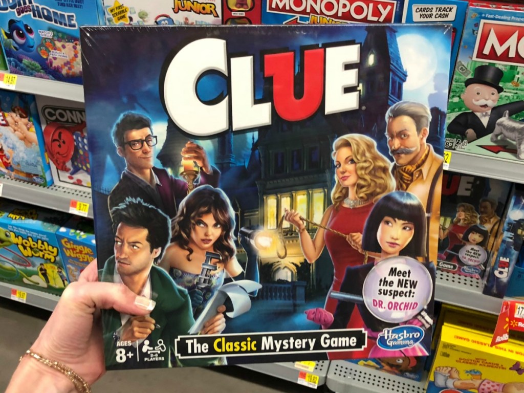 hand holding a Clue Board Game in a store