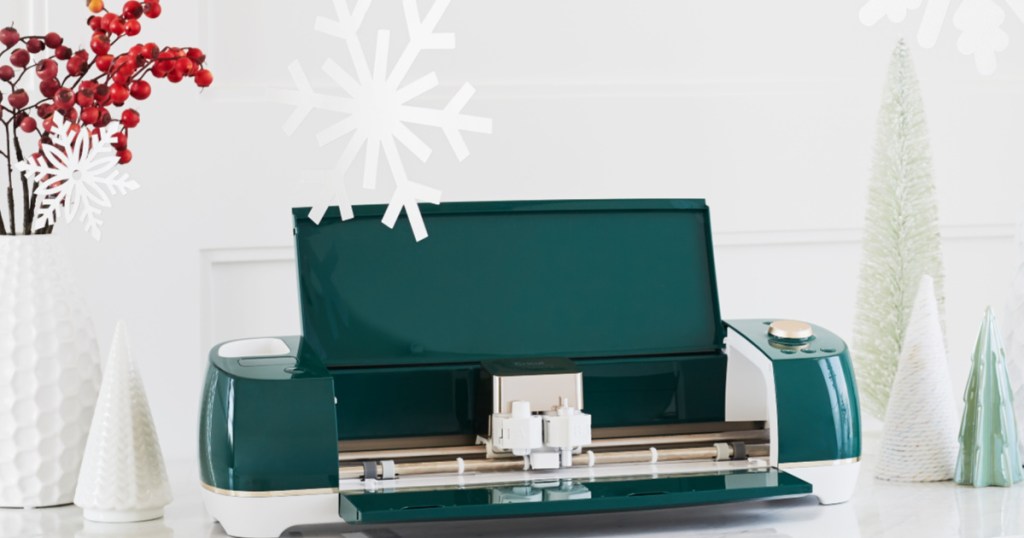 green and white cricut air machine opened with christmas decor surrounding it