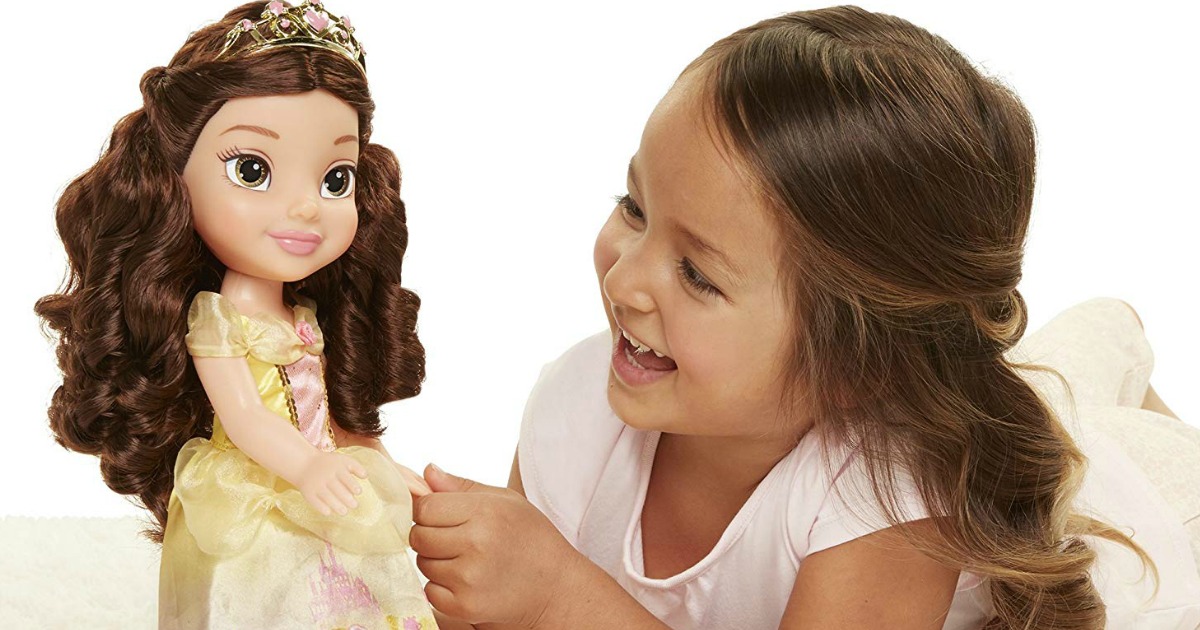 girl playing with Disney Belle doll