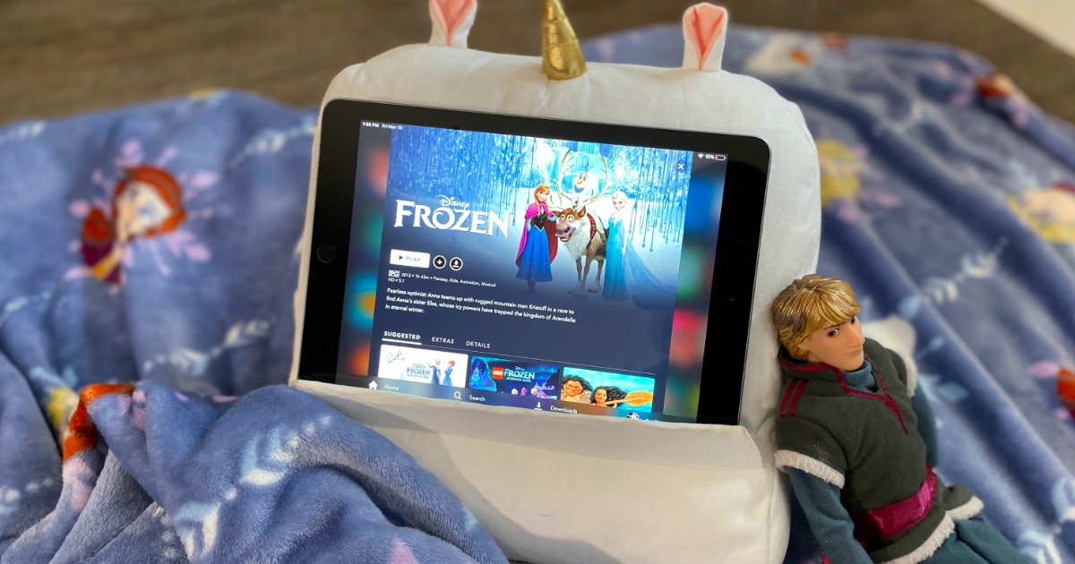 disney plus content on an ipad showing the frozen movie with a disney blanket and doll