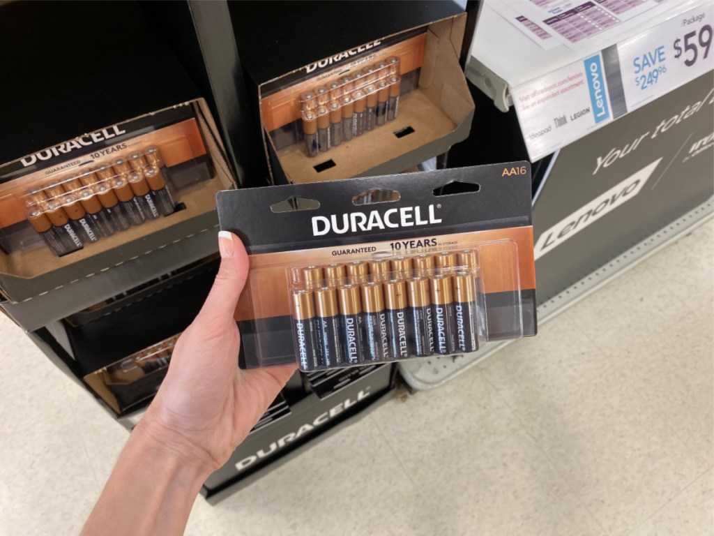 woman hand holding Duracell Batteries AA in store