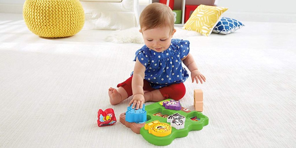 girl playing with Fisher-Price Puzzle with Animals
