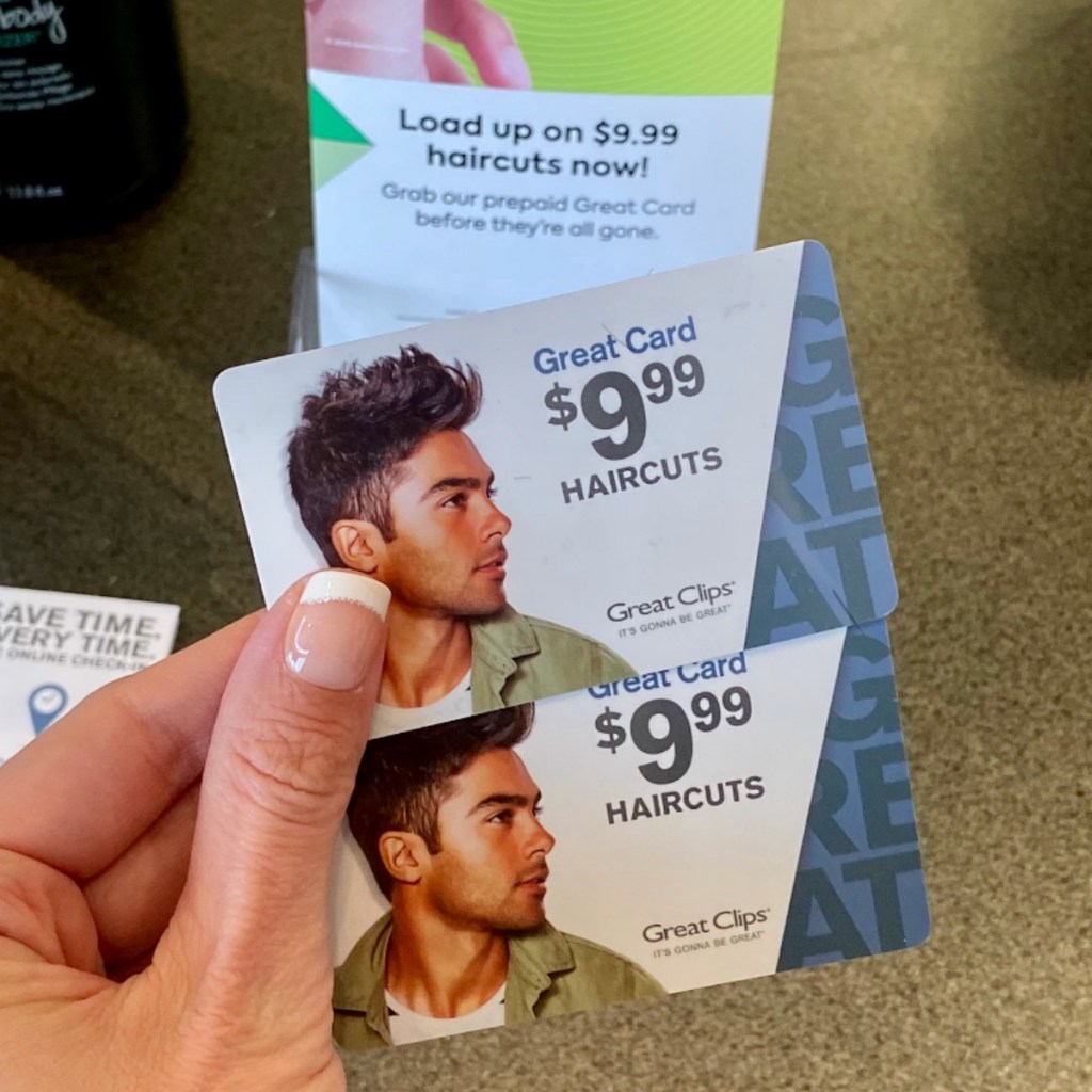 Great Clips Haircut card in hand in front of display