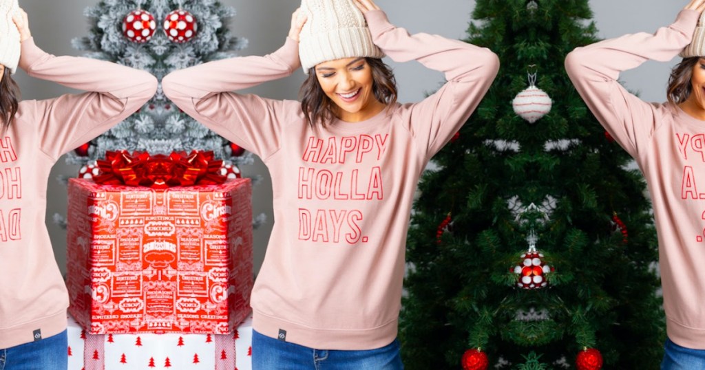 Woman wearing pink Happy Holla Days Sweatshirt