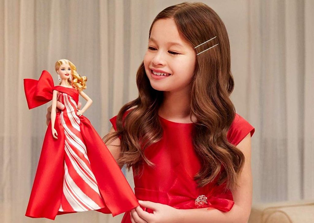 girl holding Holiday Barbie 2019
