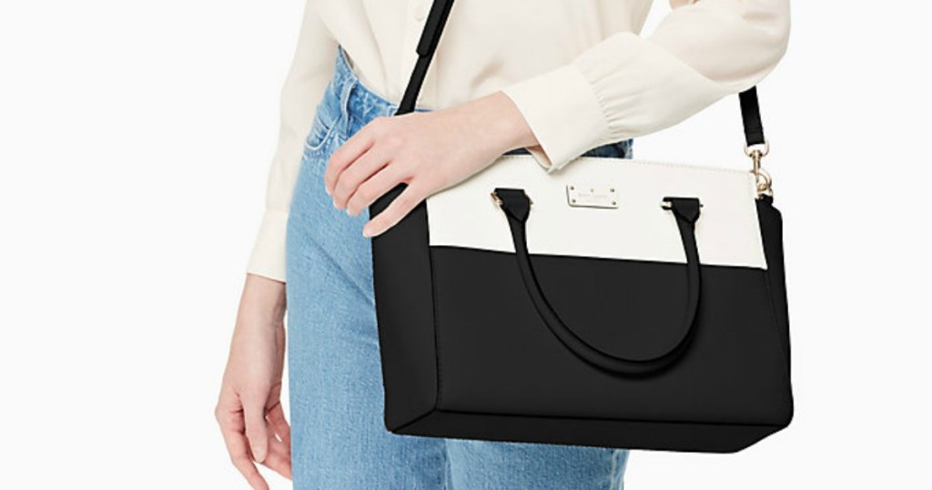 woman holding black and white bag