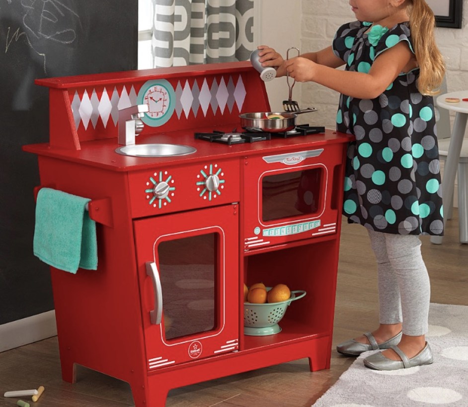 toddler girl playing with KidKraft Red Classic Kitchenette