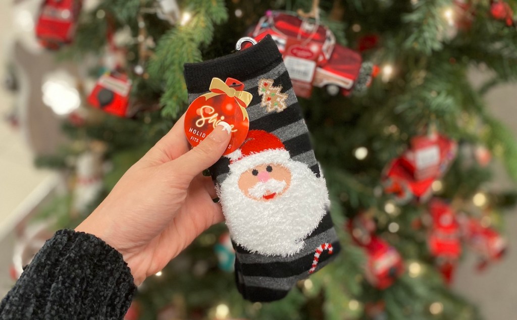 hand holding pair of Kohl's Santa Socks