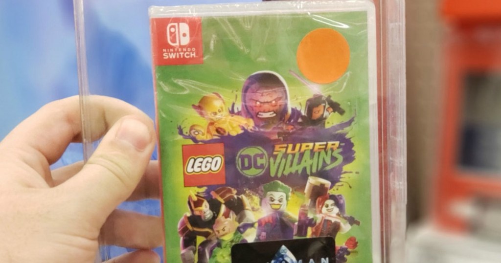 hand holding lego dc villains nintendo switch game