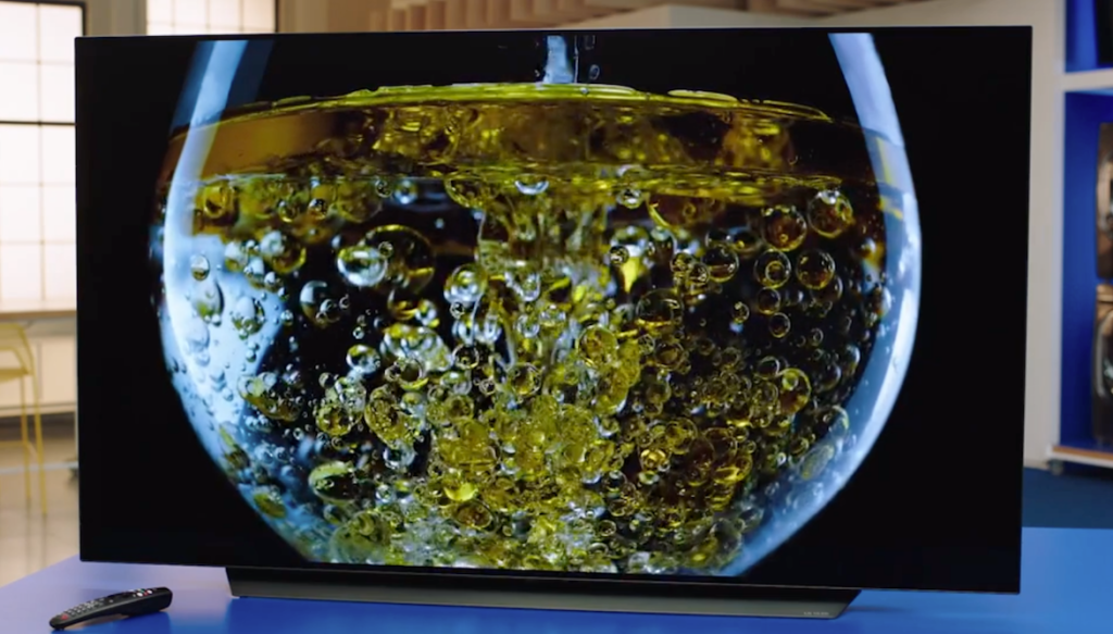 TV with image of glass with liquid and bubbles in it