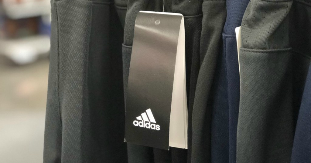 Men's adidas Training Pants in gray on in-store rack with tag