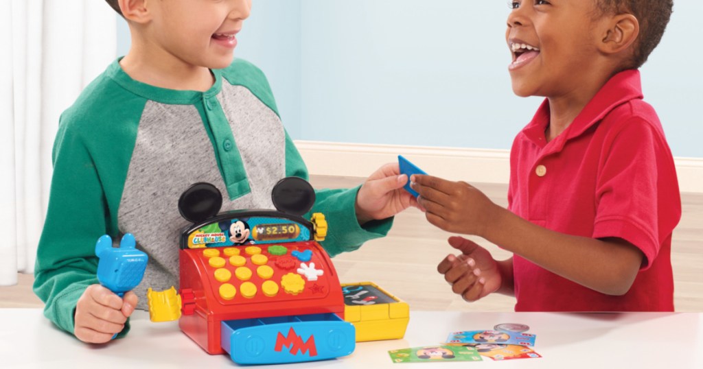 tow boys playing with mickey mouse clubhouse cash register
