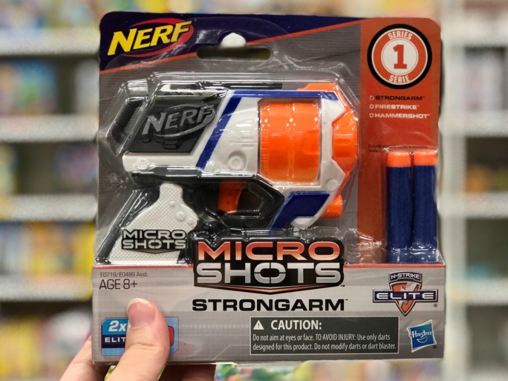MicroShots NERF gun in hand in-store near NERF in store display
