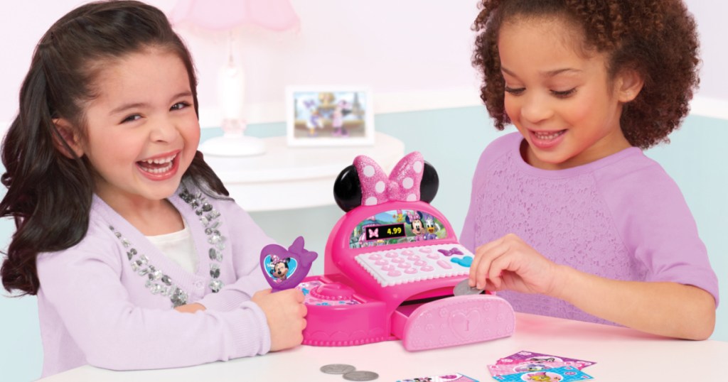 two girls playing with minnies happy helpers bowtique cash register
