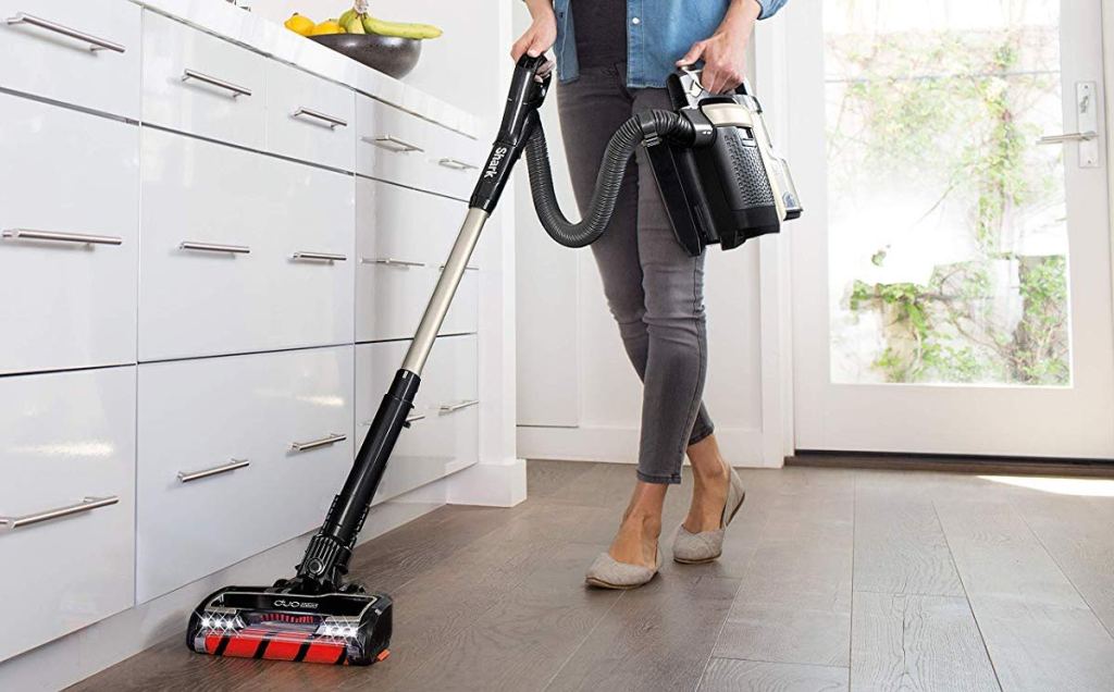 woman cleaning the floor with a vacuum