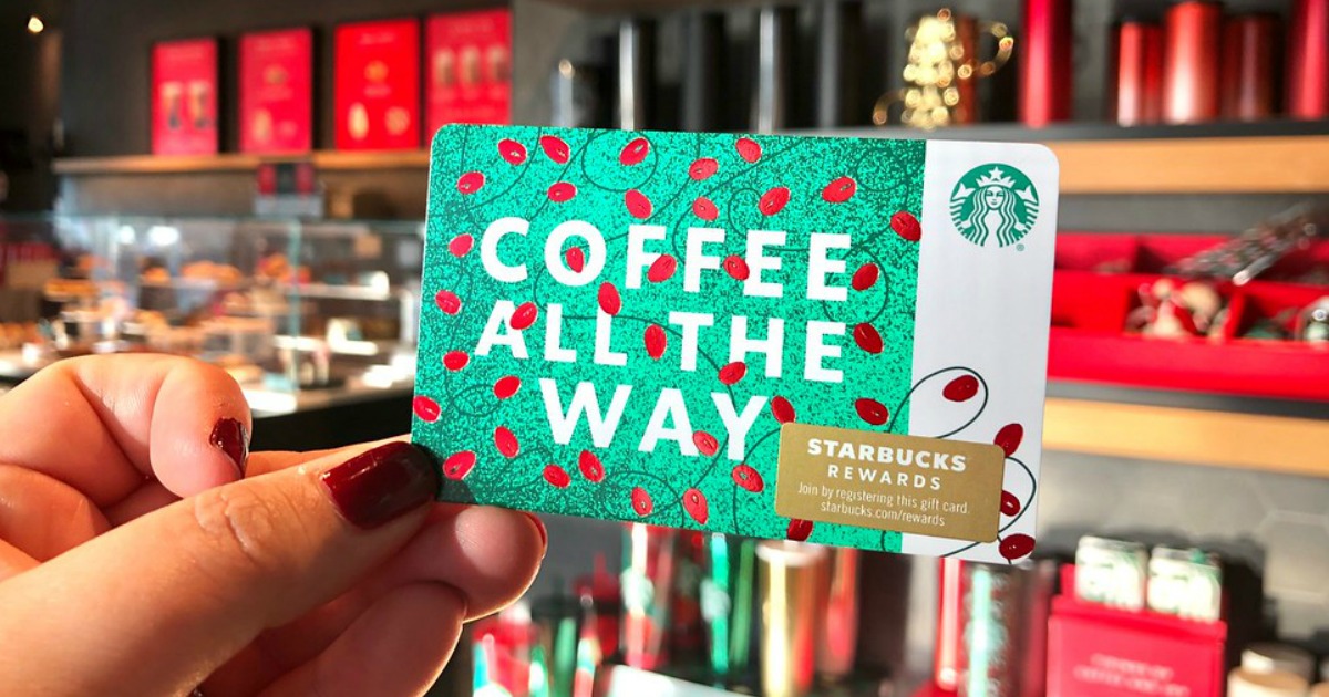 Woman holding christmas themed Starbucks Gift Card