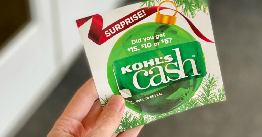 Hand holding surprise Kohl's Cash coupon