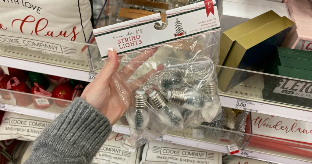 woman holding Target holiday string lights