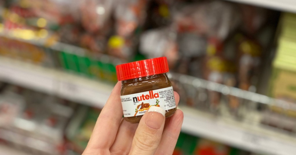 hand holding up tiny jar of nutella 