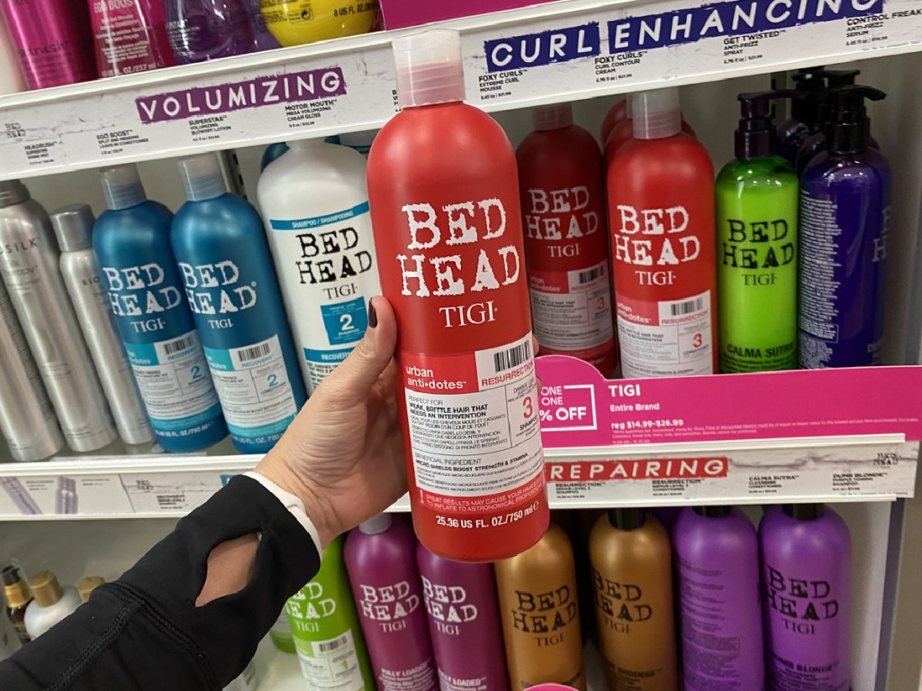 hand holding large bottle of conditioner in store
