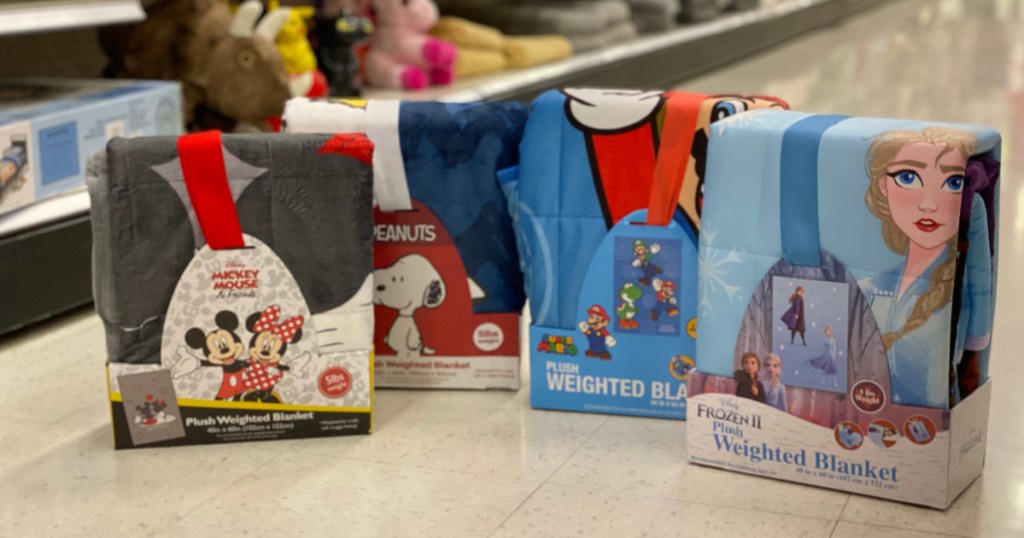Weighted Blanket Frozen 2, Mickey Mouse, Mario and Peanuts on the floor of target