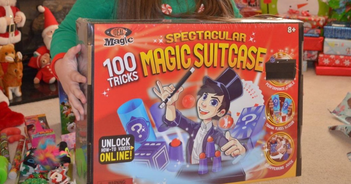 girl holding the ideal magic 100 tricks magic suitcase