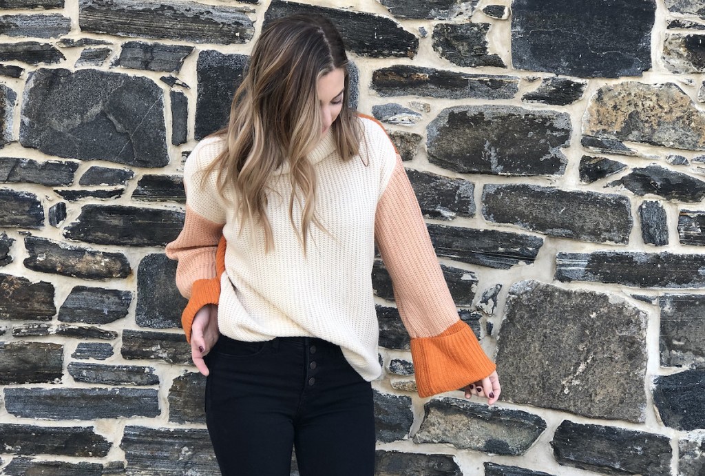 woman wearing a beige and orange sweater 