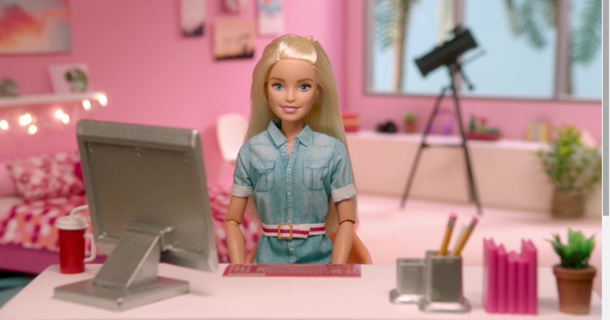 Barbie sitting at office desk