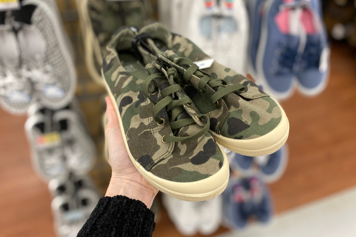holding camo time and true shoes