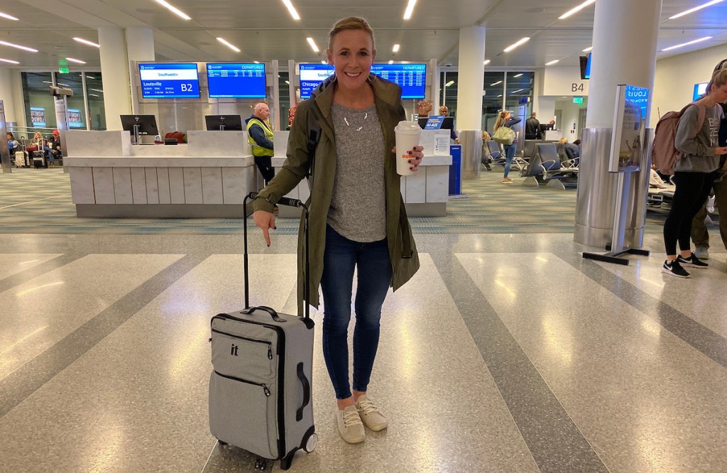 collin standing in airport with IT luggage