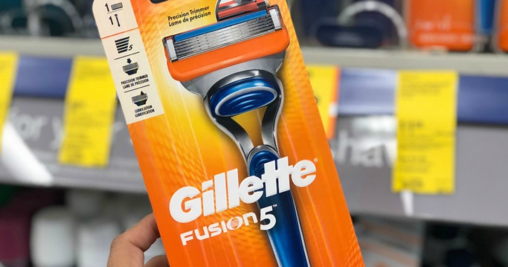 hand holding gillette razor up by store display
