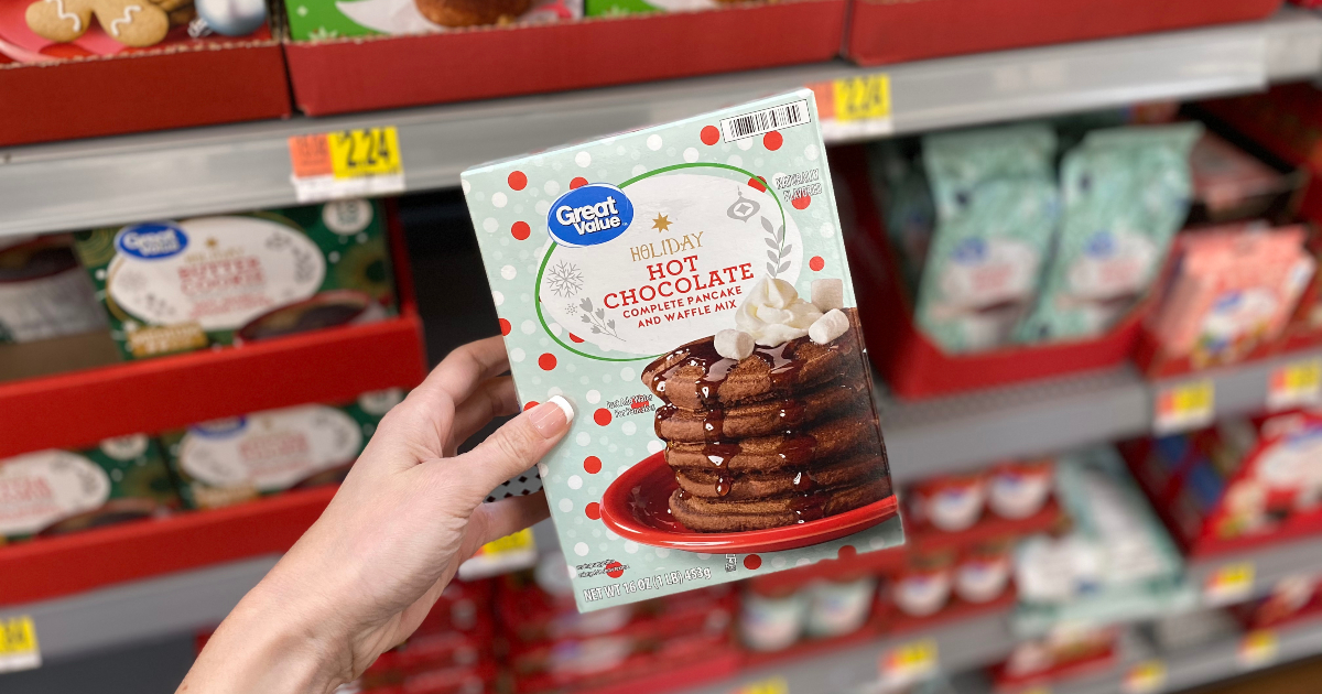 Woman holding box of Great Value Holiday Hot Chocolate Pancake & Waffle Mix