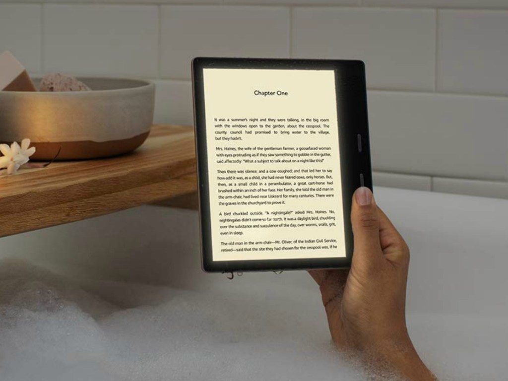 hand holding kindle reader in bath