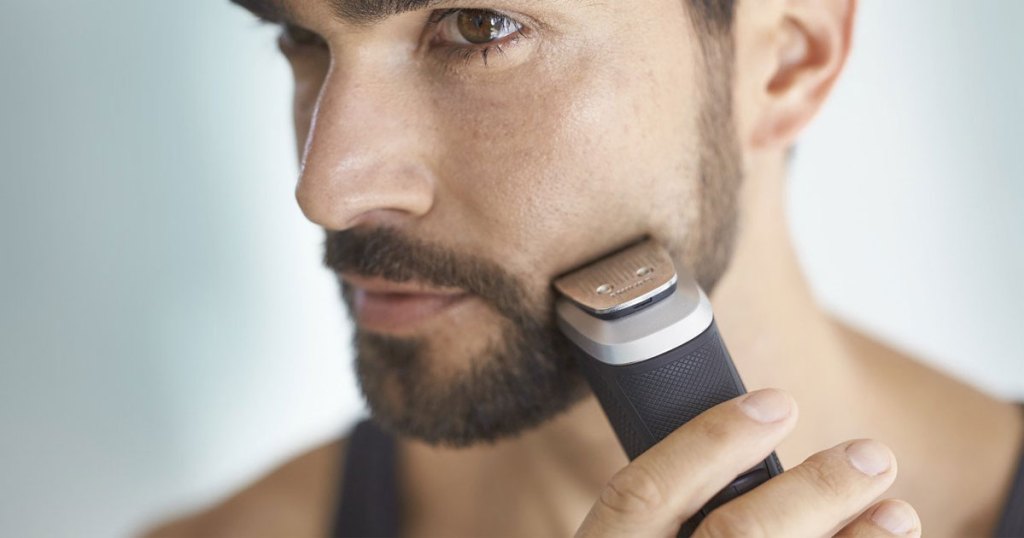 man using Philips Norelco Multigroom 5000 Trimmer to trim beard