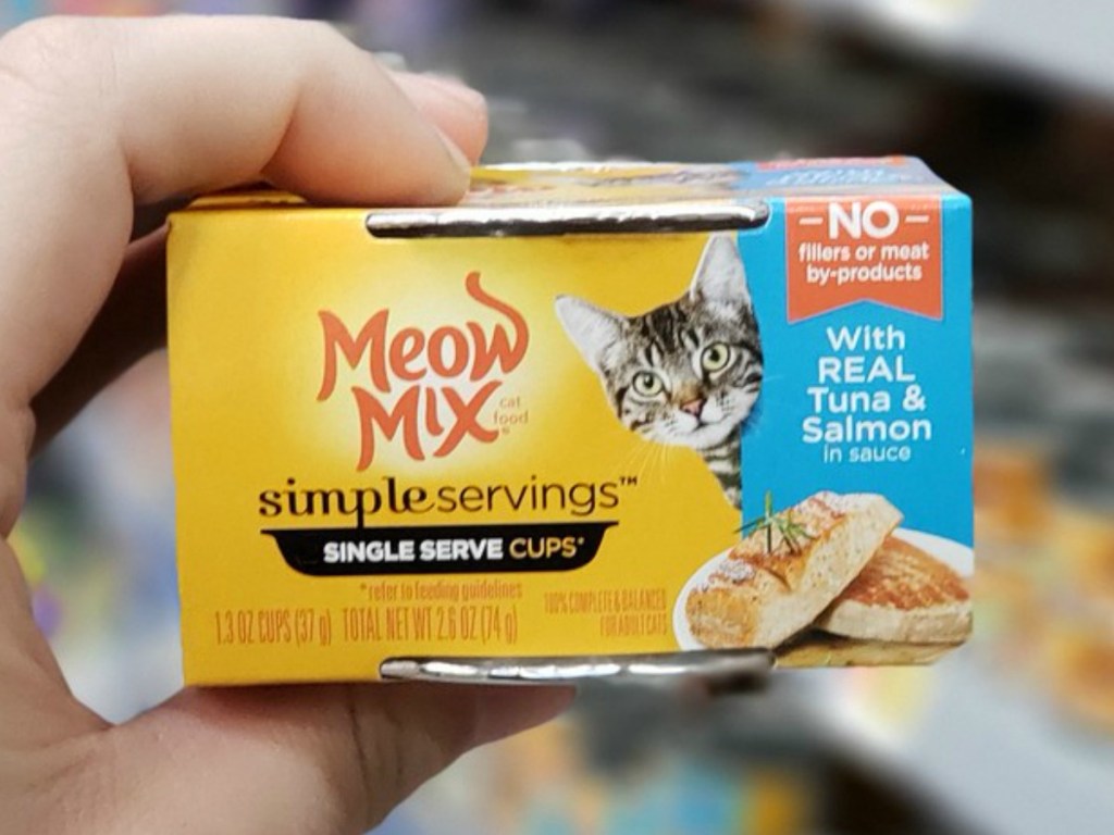 hand holding pack of cat food