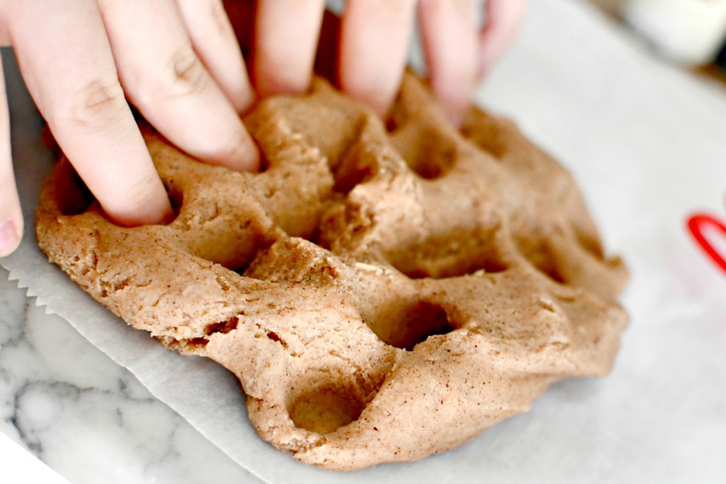 molding gingerbread play dough with hands