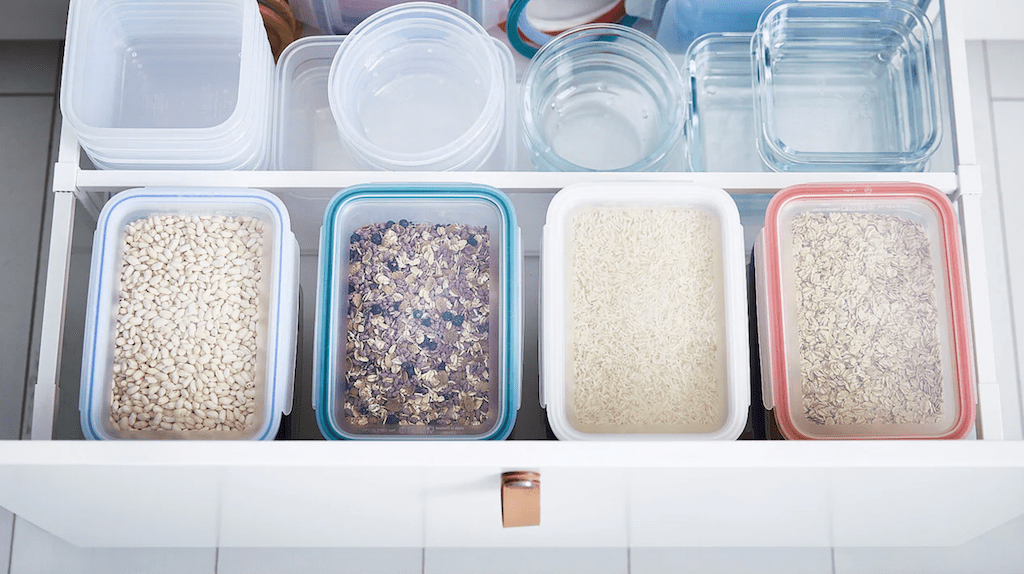 organized pantry drawer with IKEA containers 