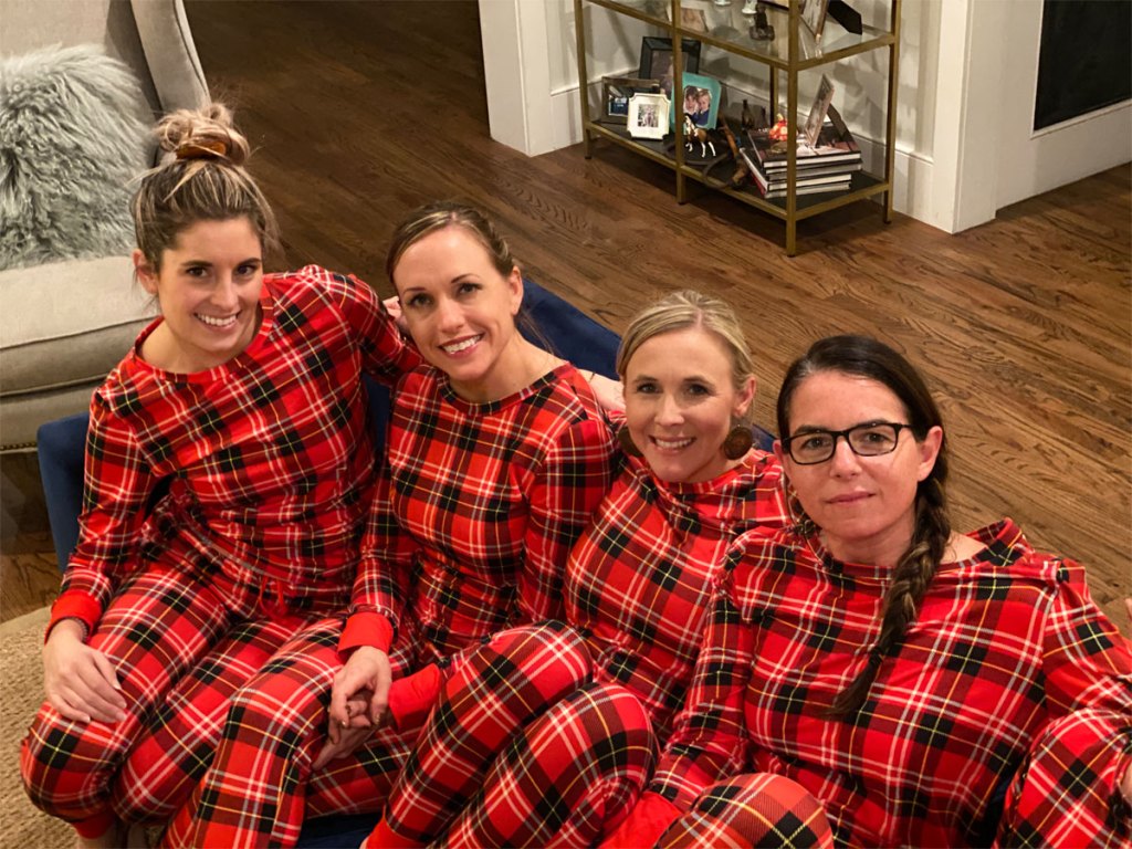 Hip team sitting on couch in matching red plaid pajamas