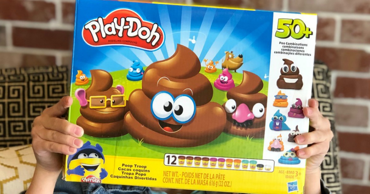 child holding up Play Doh Poop Troop box
