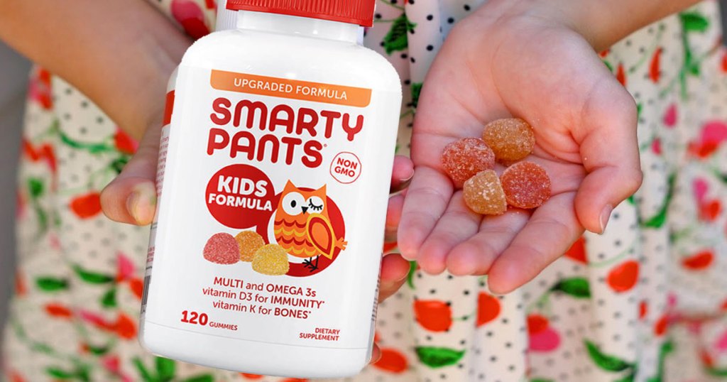 smarty pants kids formula girl holding bottle and vitamins in hand