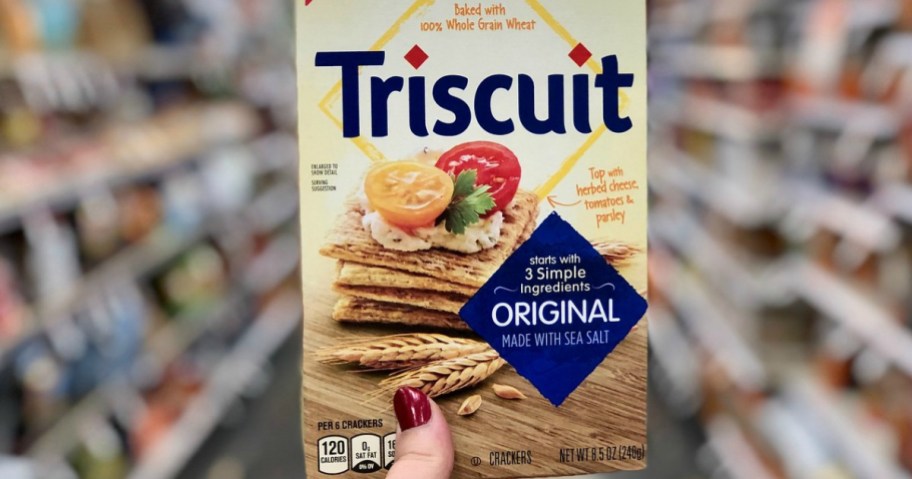 hand holding a box of Triscuit crackers