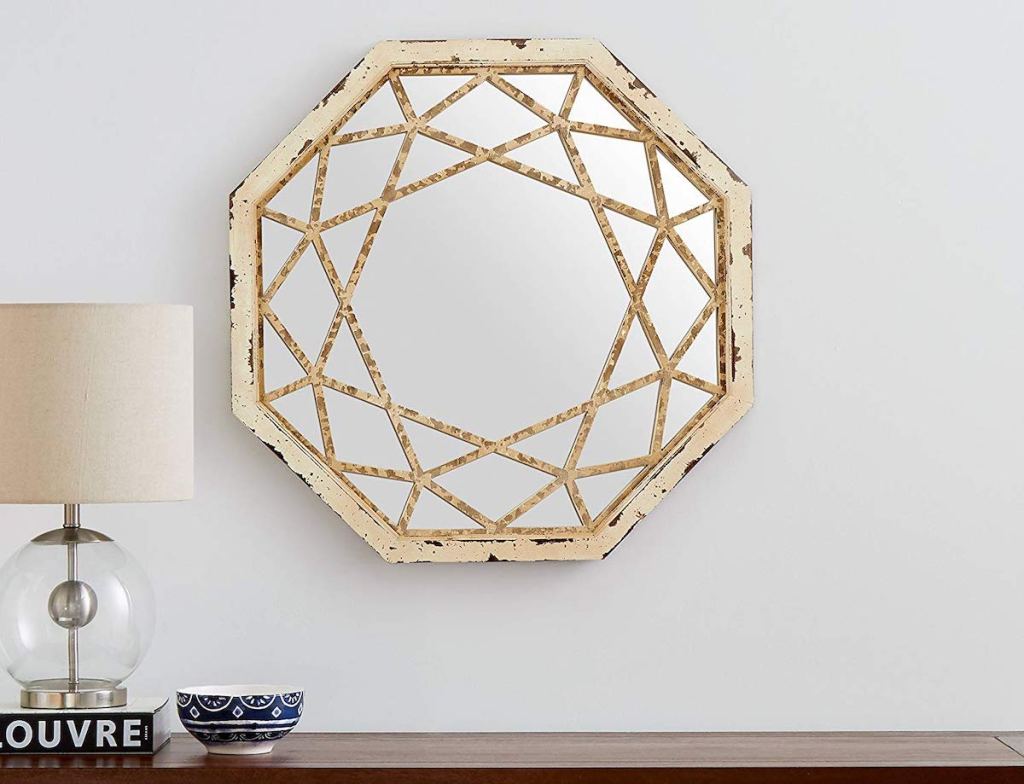 octagon shaped mirror hanging on gray wall 