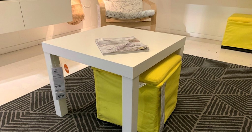 IKEA white side table on black carpet 