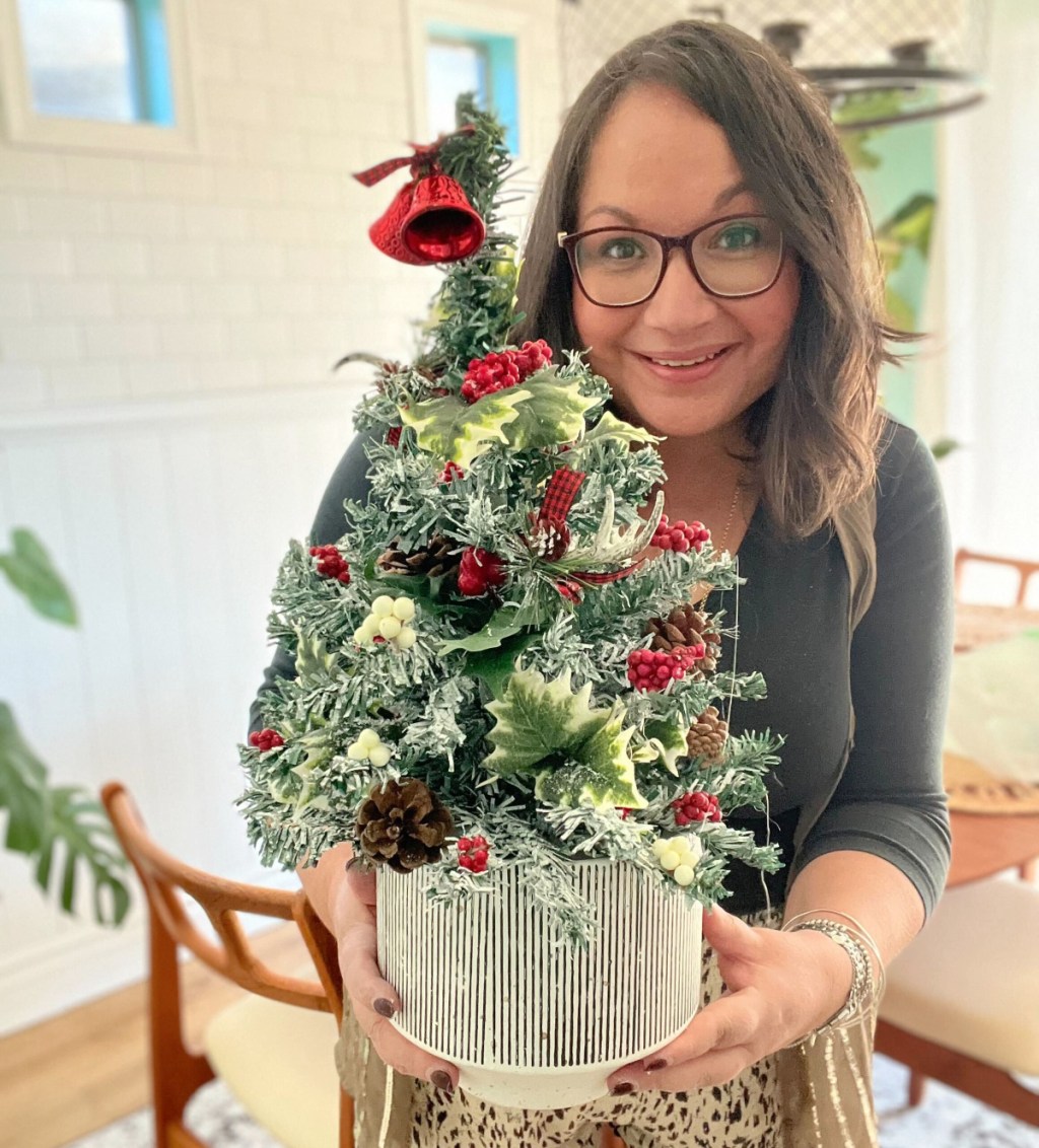 woman holding a dollar tree diy christmas decor craft