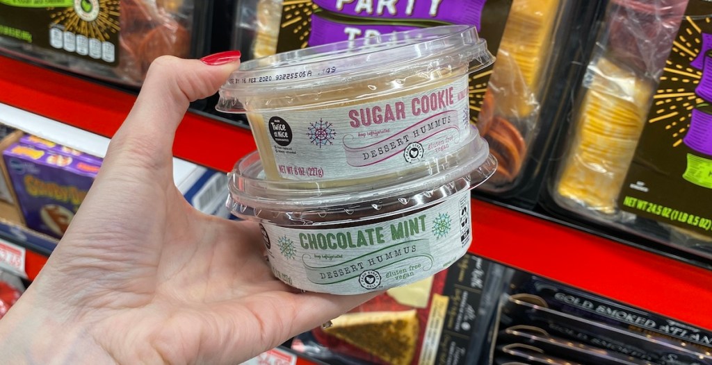 hand holding containers of ALDI Sugar Cookie and Chocolate Mint Hummus
