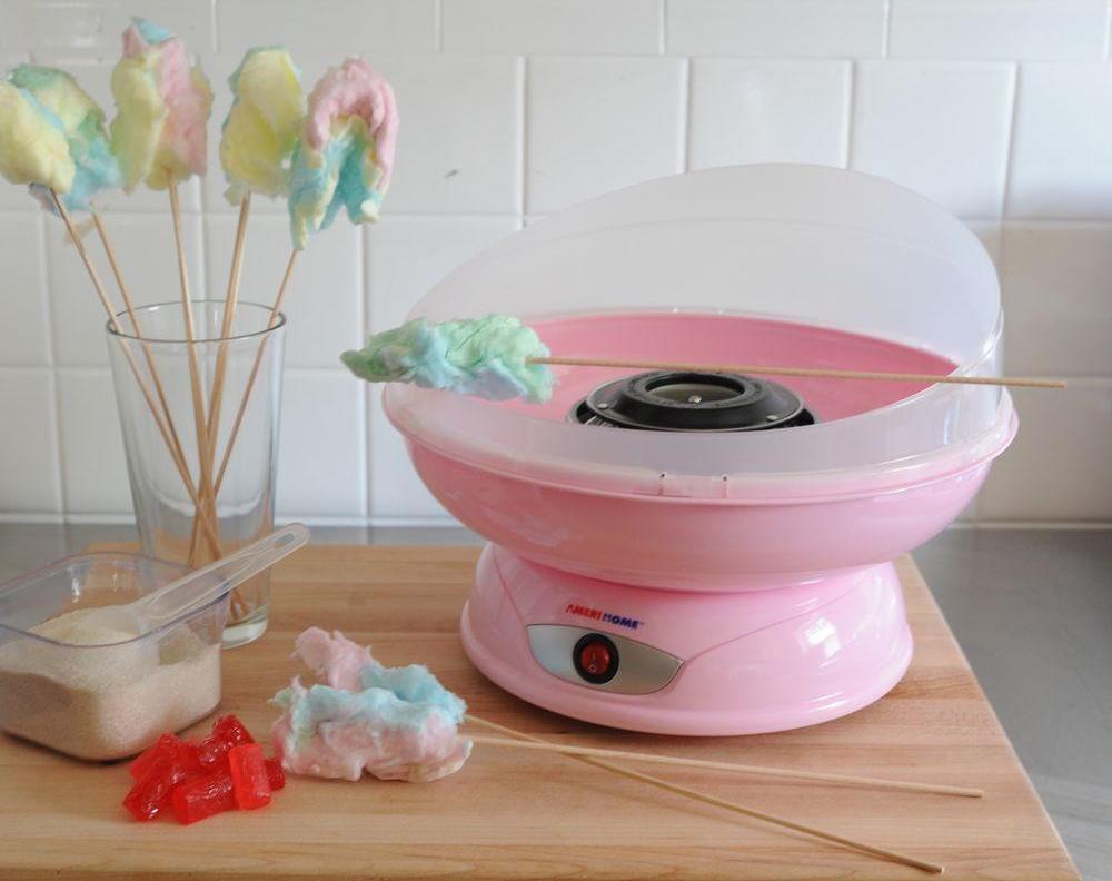 cotton candy maker next to cotton candy, sugar and candy