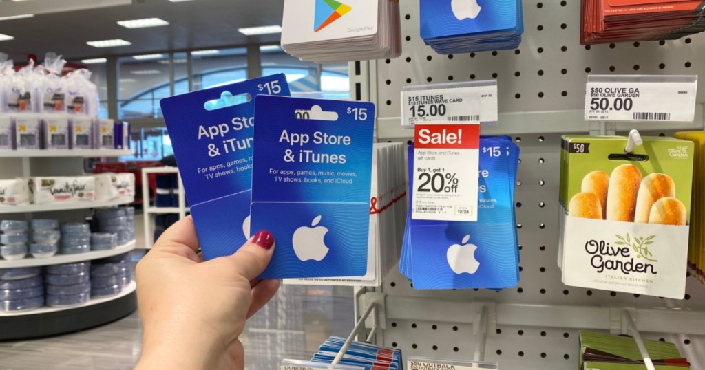 hand holding up two app store itunes gift cards