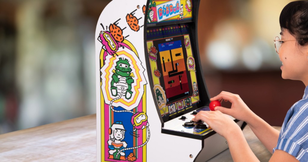 girl playing arcade game with blurred background