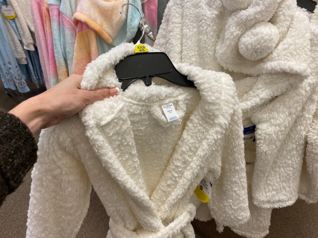 hand holding an Arizona Girls Robe on hanger