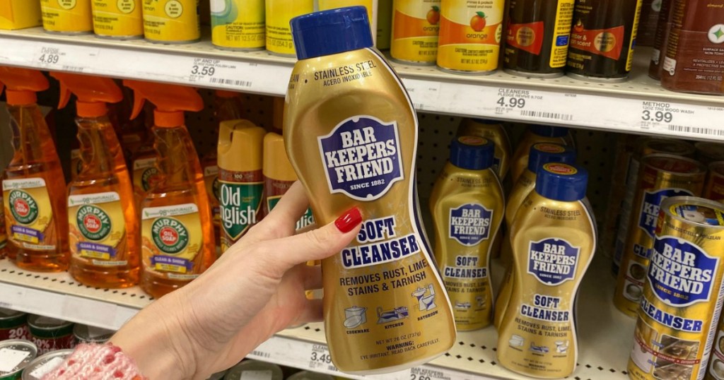 Bar Keepers Friend bottle of cleanser in hand in front of display at Target